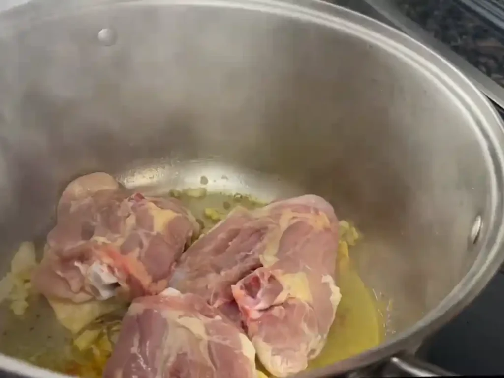 Chicken being sauteed for Puerto Rican Chicken Noodle Soup.