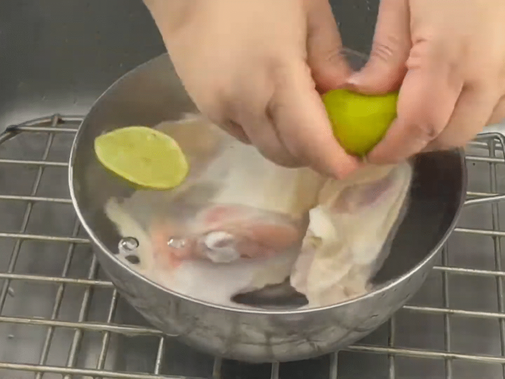 Cleaning chicken with lime for Puerto Rican Chicken Noodle Soup.