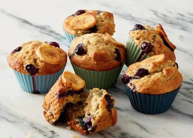Freshly baked Air Fryer Banana Blueberry Muffins on a cooling rack