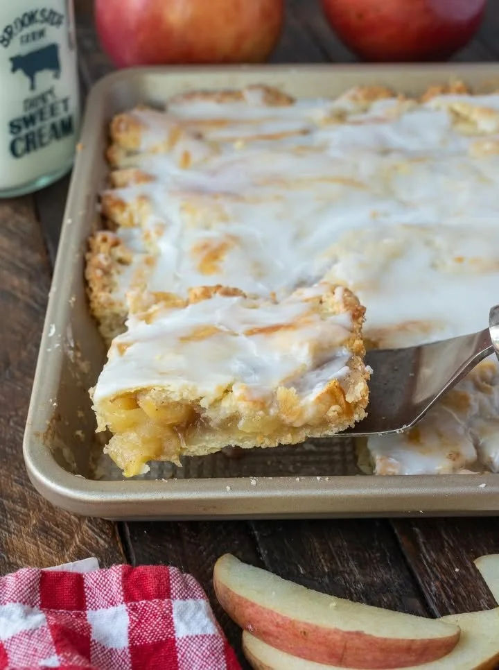 Homemade apple pie bars topped with caramel drizzle and cinnamon.