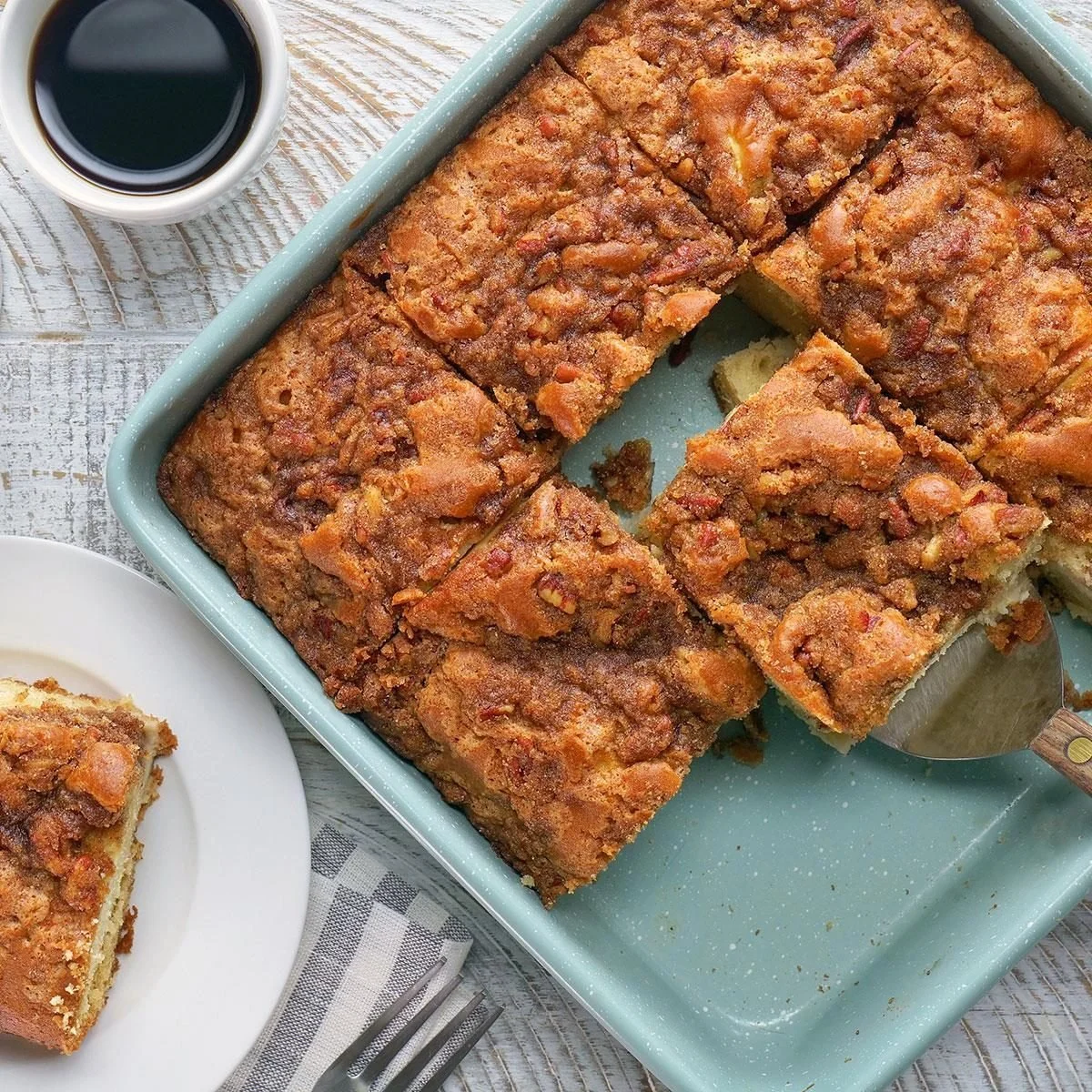 Delicious apple pie bars topped with cinnamon and topped with a scoop of ice cream.