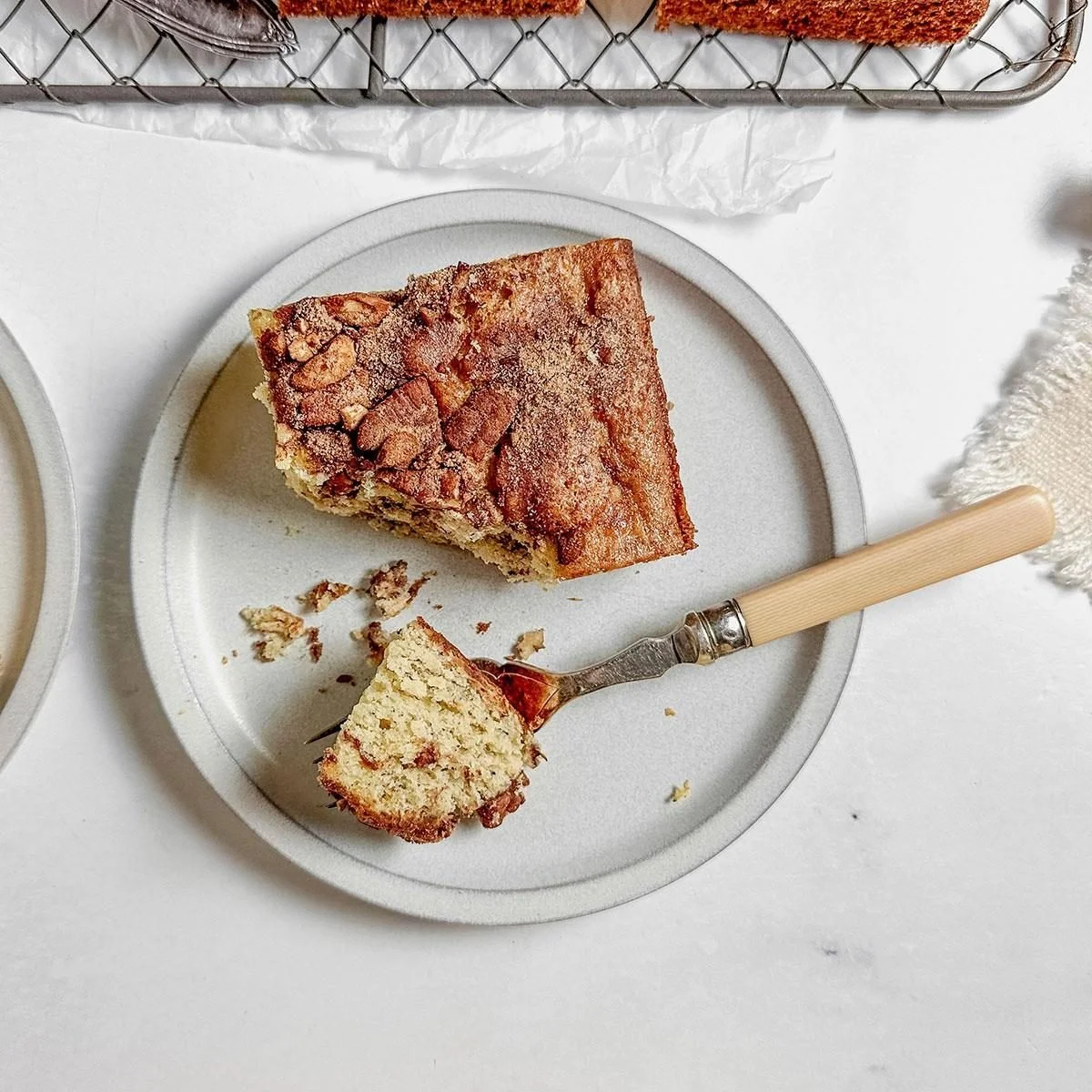 Delicious slice of Banana Coffee Cake on a plate with a fork