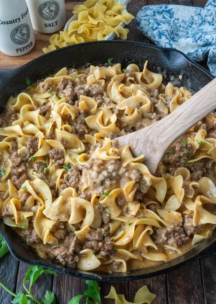 Bowl of beef noodles garnished with herbs, showcasing a delightful meal.