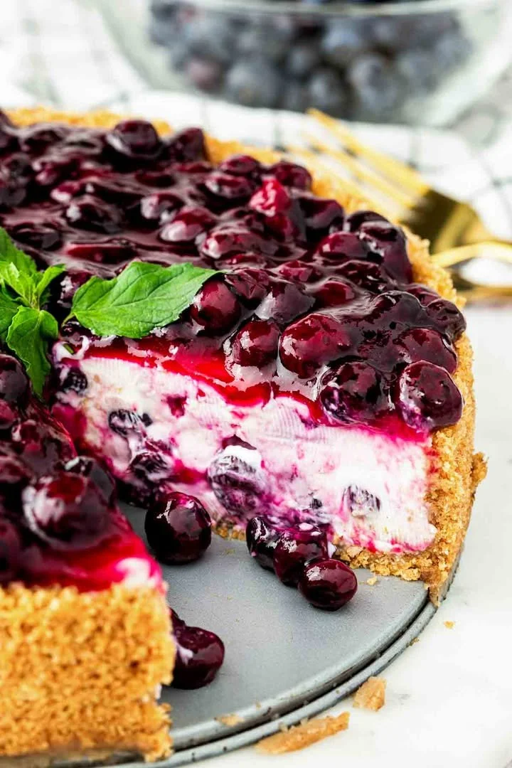 Delicious slice of blueberry cheesecake topped with fresh blueberries