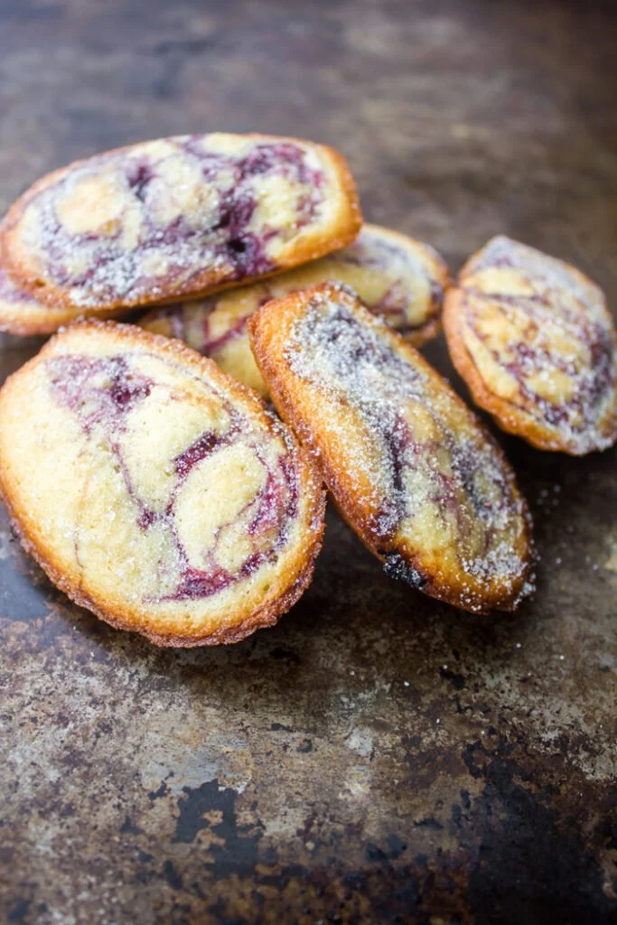 Blueberry cherry fruit swirled lemon madeleines on a plate