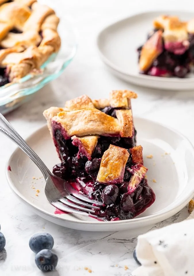Freshly baked blueberry pie with golden crust and juicy berries.