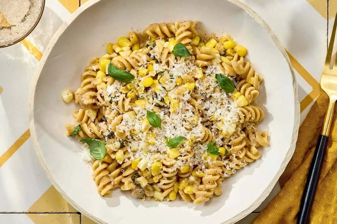 Plate of Brown Butter Corn Pasta topped with fresh herbs