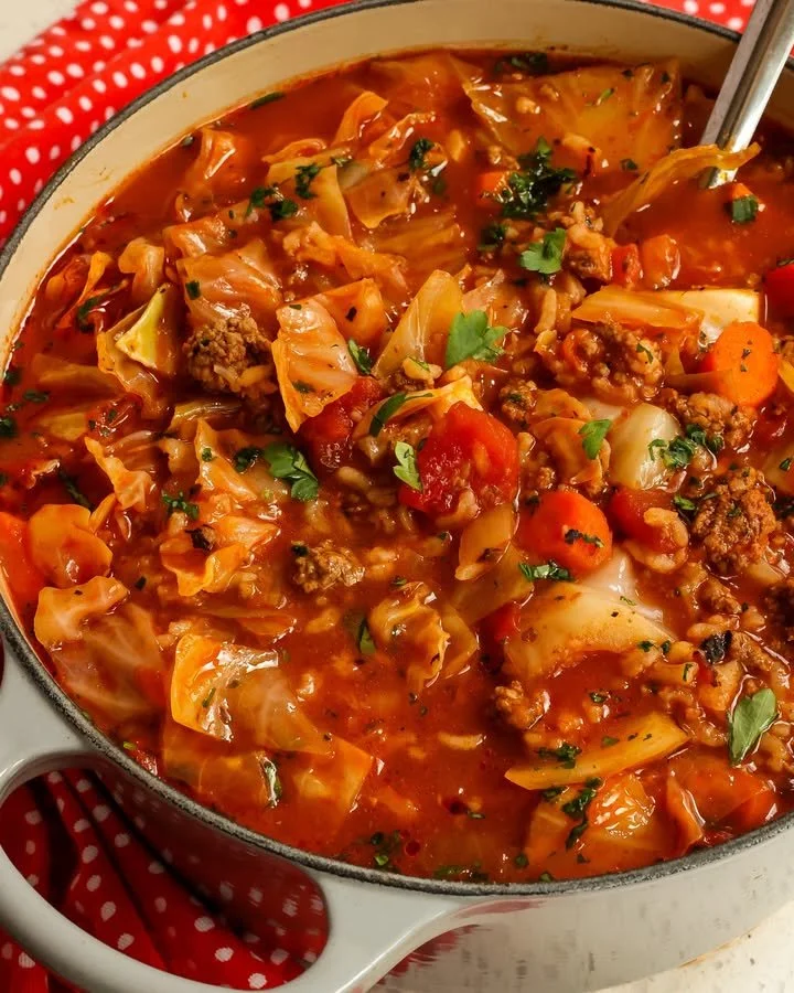 A bowl of delicious Cabbage Roll Soup garnished with herbs.