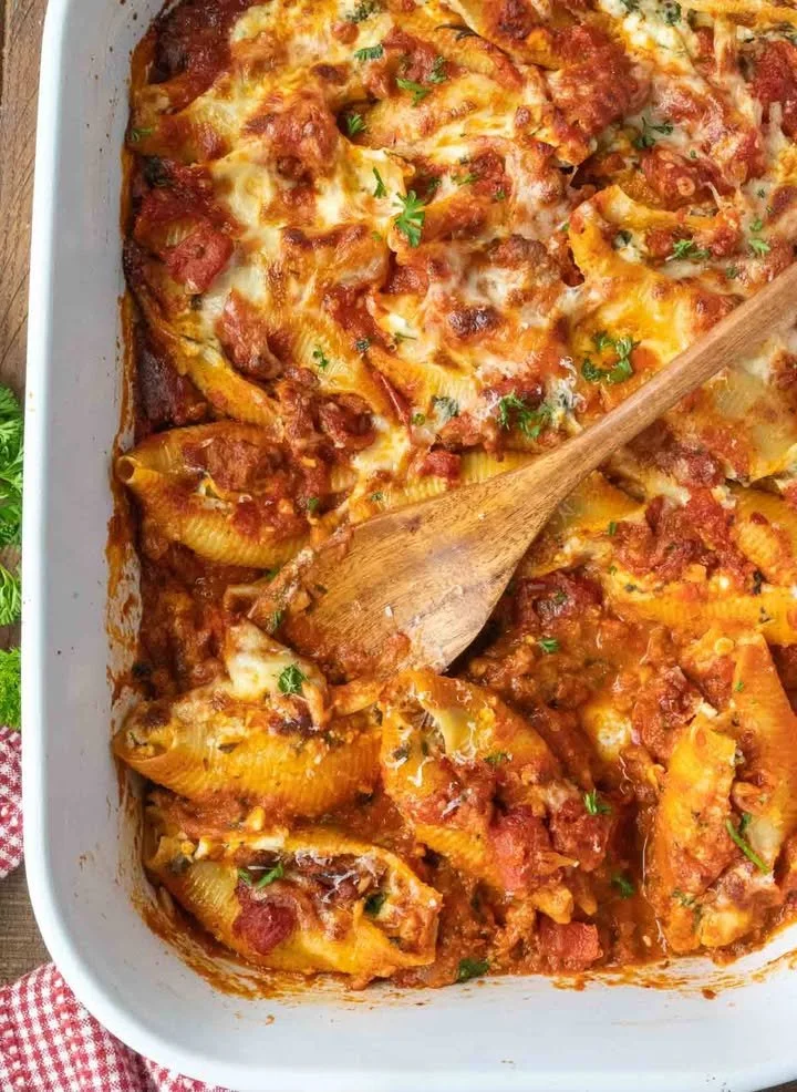 Delicious cheese stuffed shells baked with marinara sauce and topped with herbs
