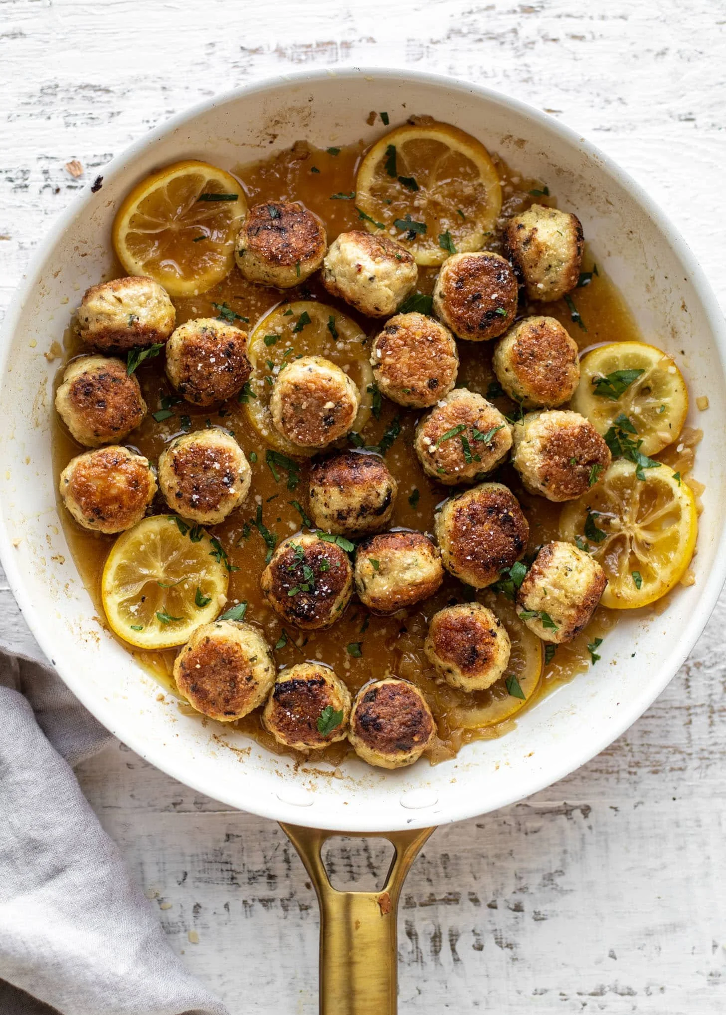 Chicken Romano meatballs served with a fresh garnish.