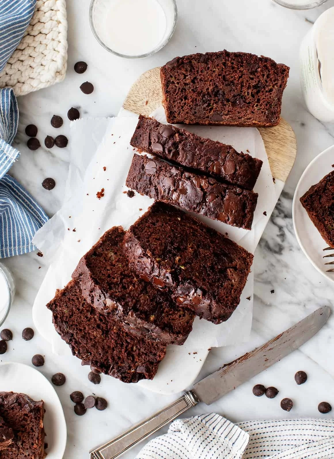 Delicious slices of homemade chocolate zucchini bread on a wooden table.