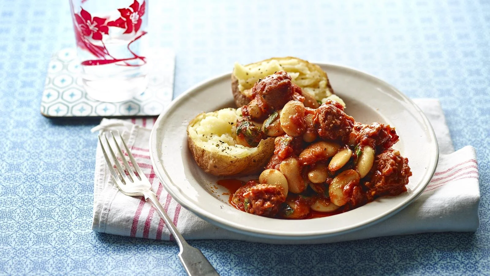 Chorizo Butterbean Baked Potatoes topped with herbs and spices
