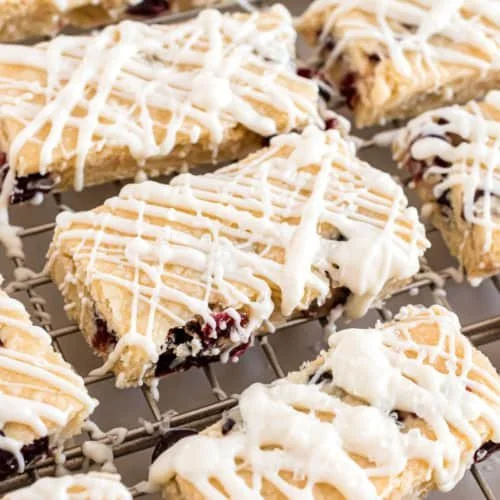 Cranberry White Chocolate Shortbread cookies on a plate.