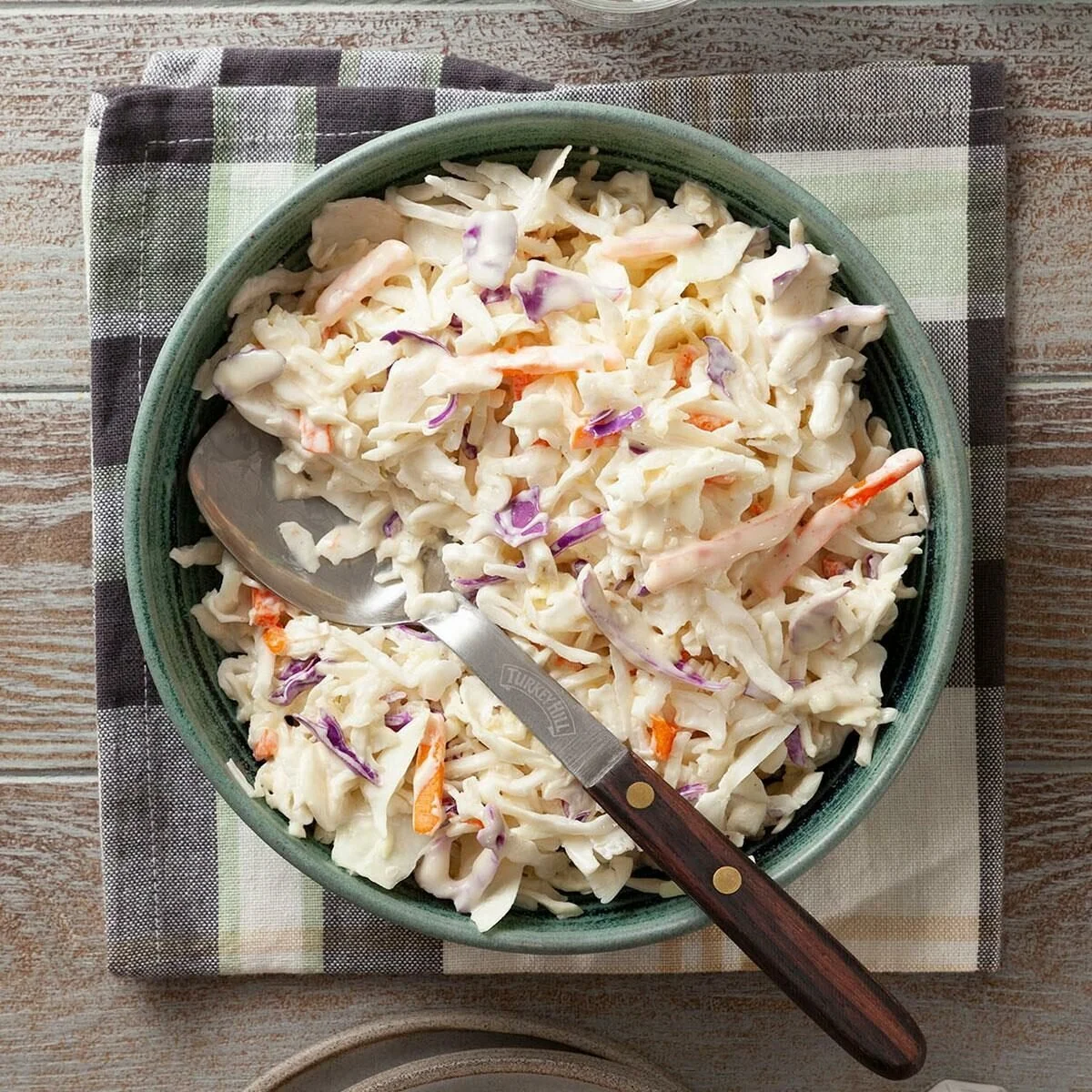 Bowl of creamy coleslaw with fresh cabbage and dressing