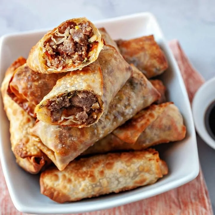 Plate of crispy air fryer egg rolls served with dipping sauce