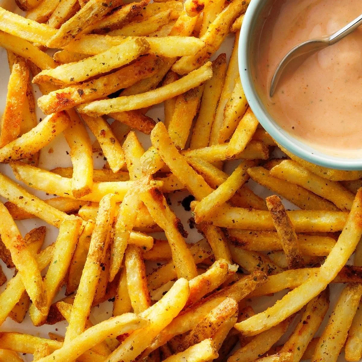 A bowl of crispy ranch fries seasoned with herbs and spices