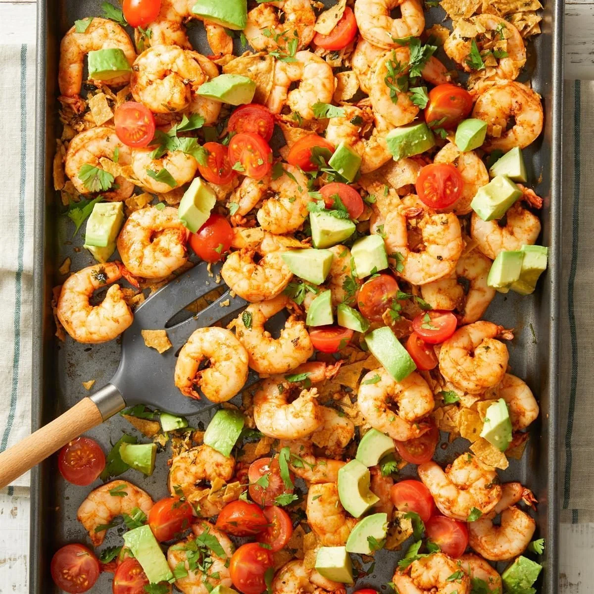 Plate of crunchy chili lime shrimp garnished with fresh herbs and lime