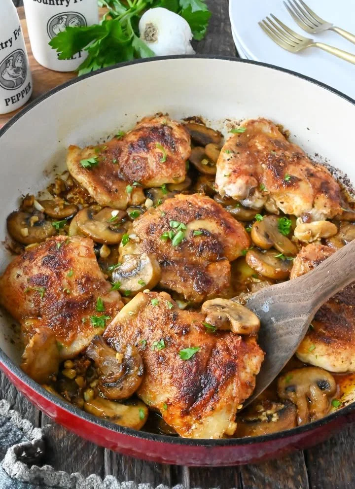 Delicious garlic mushroom chicken thighs garnished and served on a plate