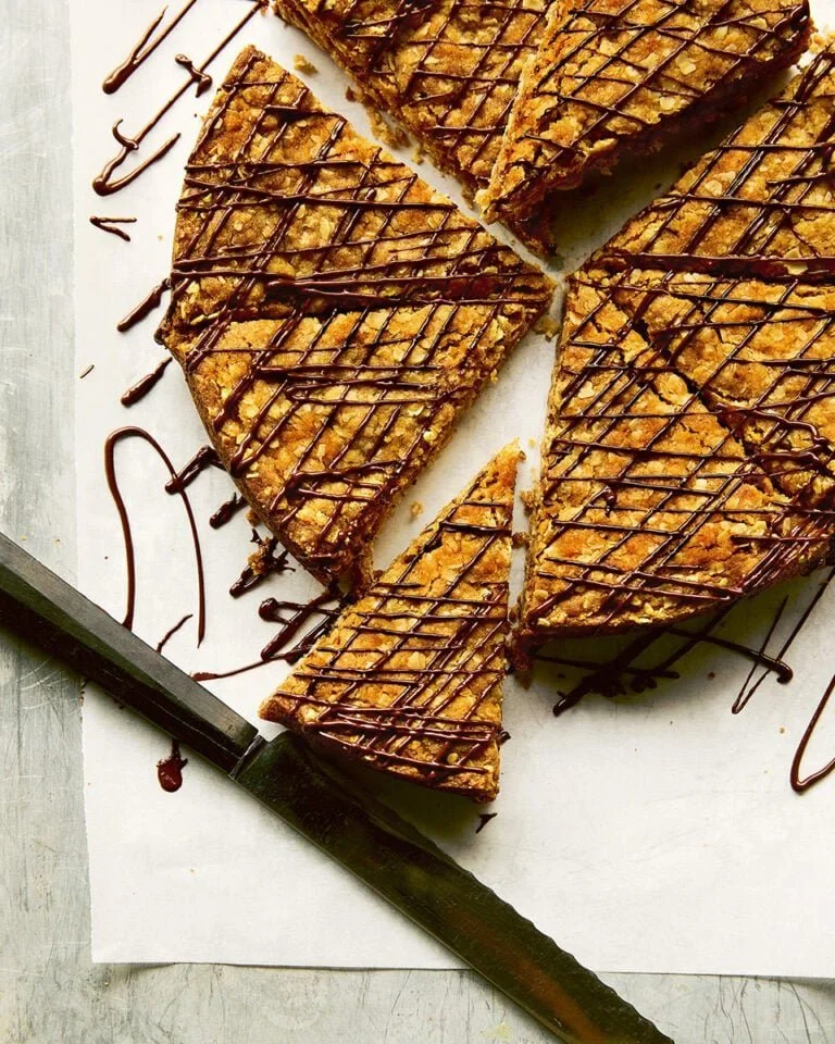 A Giant Hobnob Bignob Biscuit displayed on a rustic wooden table.