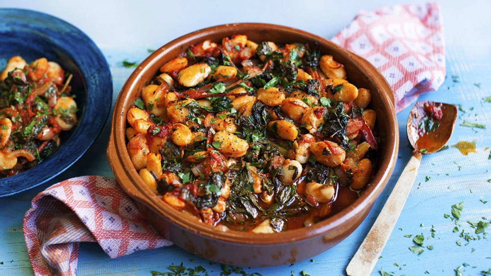Delicious Gigantes with tomatoes and greens served in a bowl.