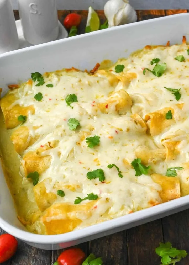 Delicious Green Chile Chicken Enchiladas topped with cheese and herbs