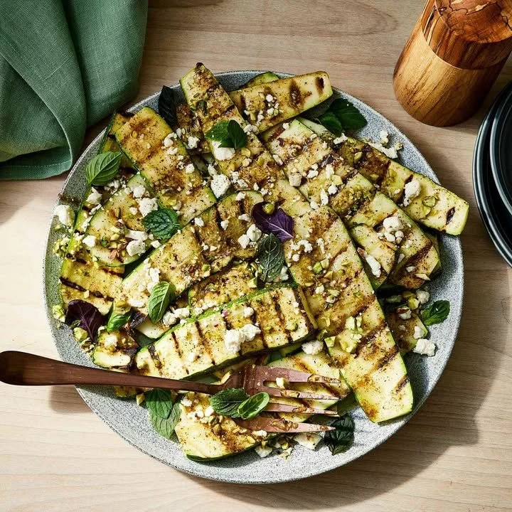 Grilled zucchini planks topped with crumbled feta cheese