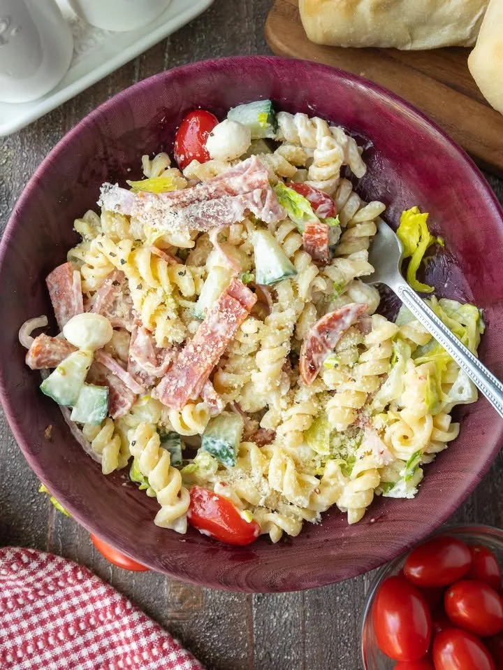 Grinder Pasta Salad with colorful vegetables and dressing in a bowl