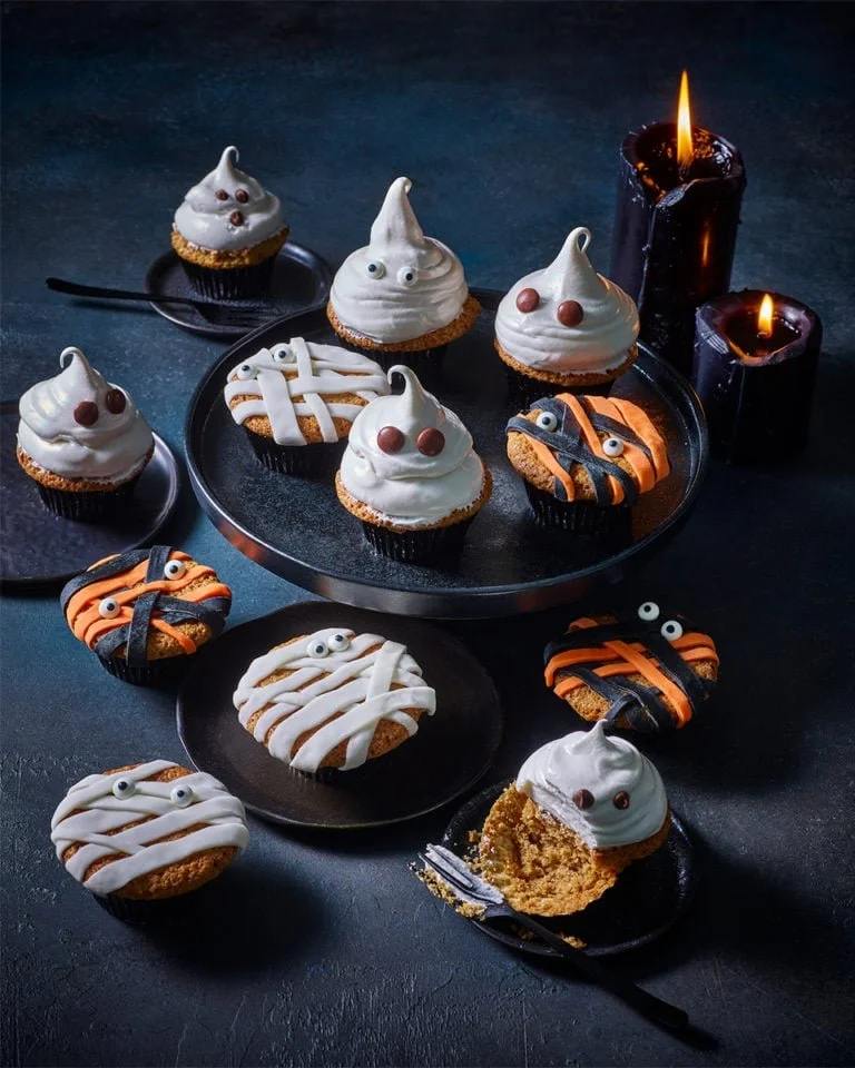 Halloween pumpkin spiced cupcakes decorated with festive frosting and pumpkin sprinkles