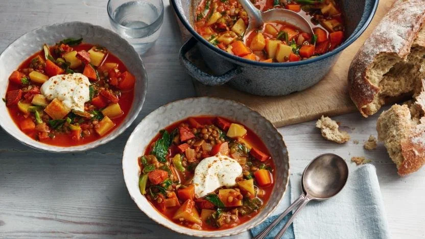 Bowl of hearty winter vegetable soup filled with fresh, colorful vegetables
