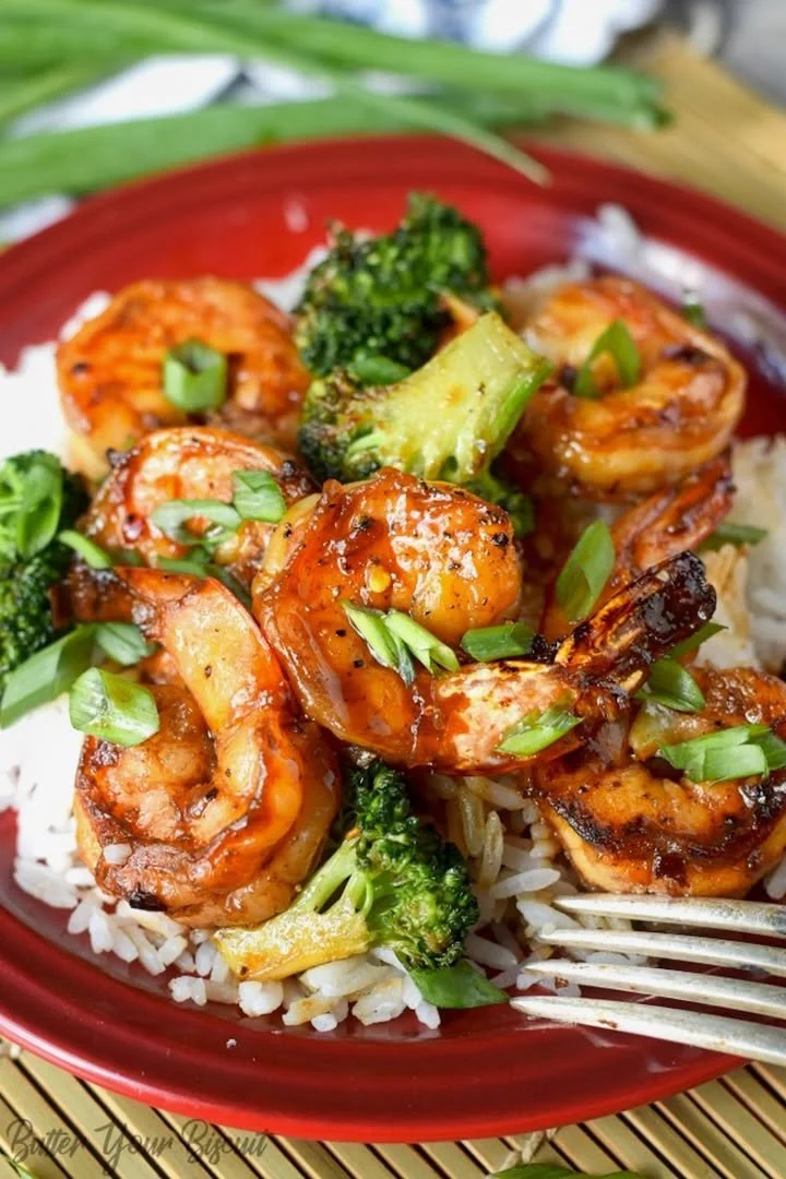 Plate of Honey Garlic Butter Shrimp garnished with herbs.