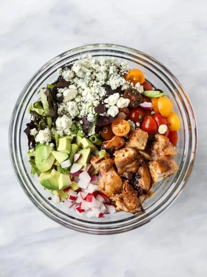 Delicious honey mustard chicken chopped salad with colorful vegetables