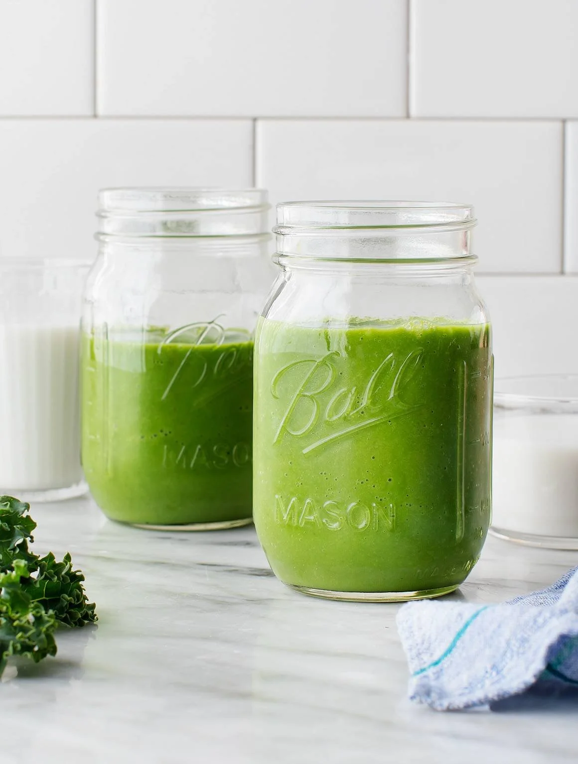 Healthy kale smoothie in a glass with fresh ingredients