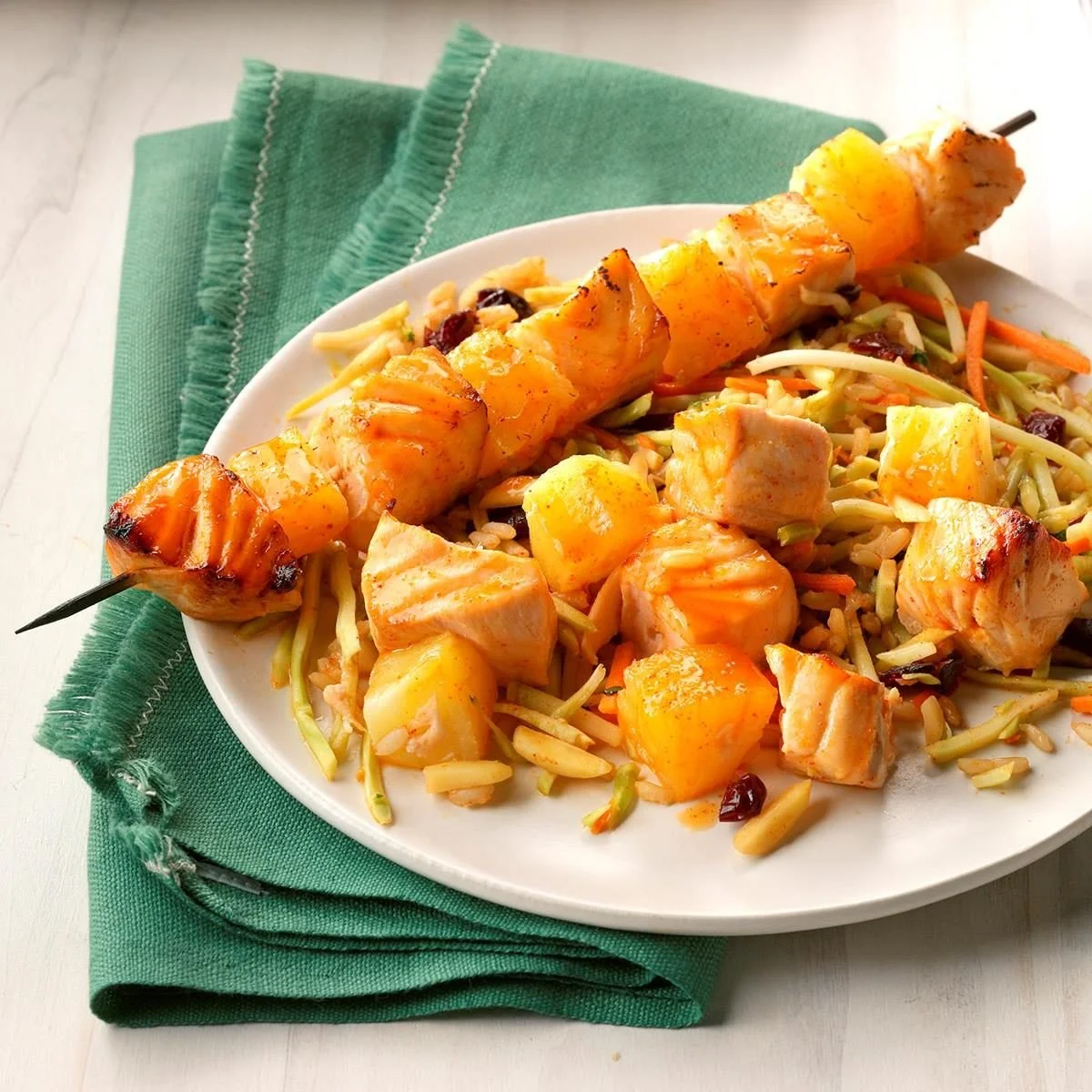 Grilled Korean salmon skewers served with vibrant rice slaw.