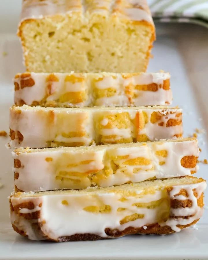 Delicious lemon pound cake slice on a plate with lemon garnish