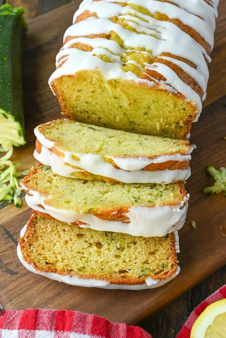 Freshly baked lemon zucchini bread on a wooden cutting board