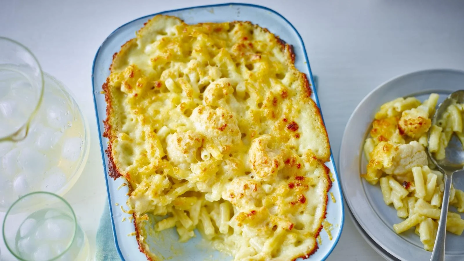 Bowl of creamy Macaroni Cauliflower Cheese topped with golden breadcrumbs