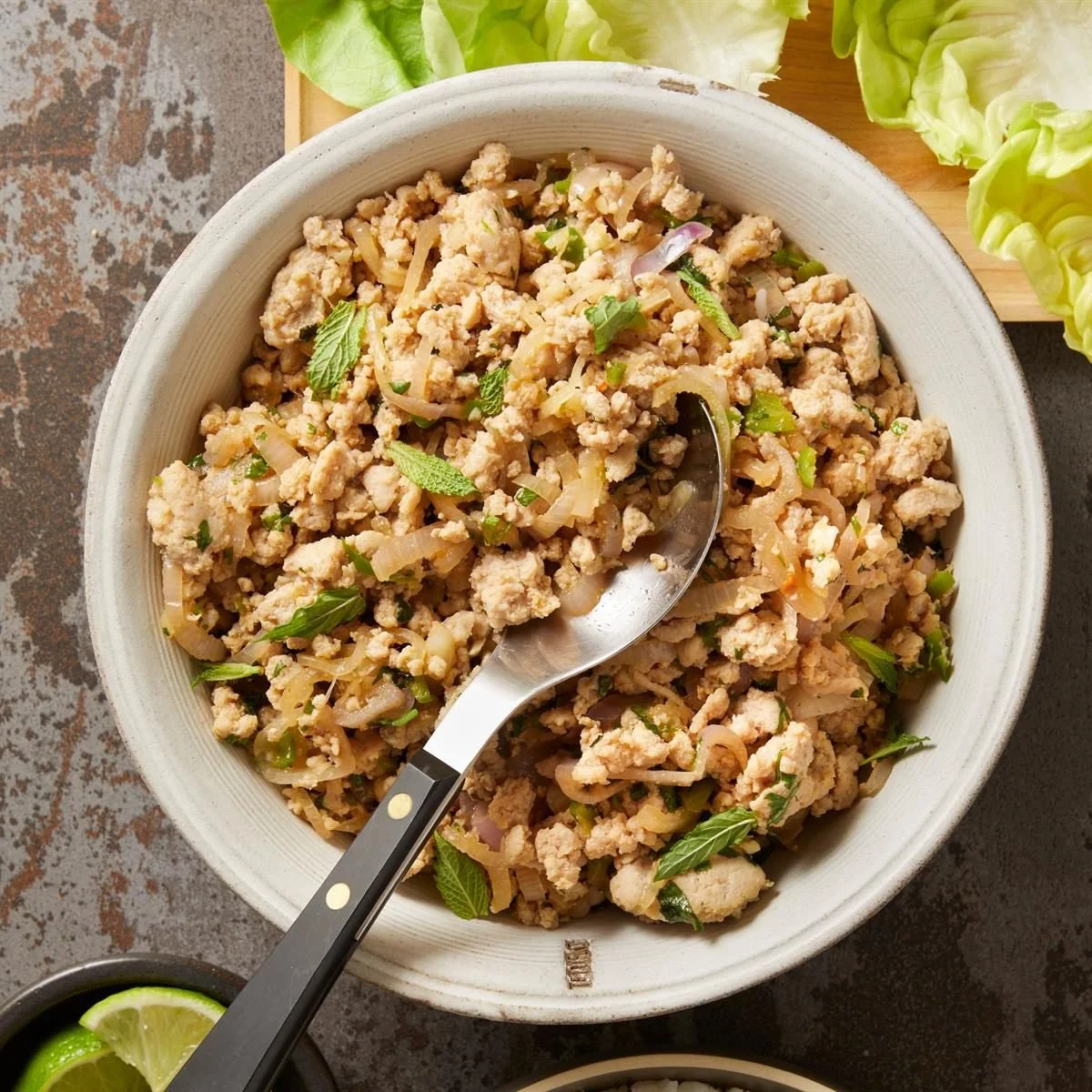 Bowl of fresh minced chicken salad with vegetables and herbs
