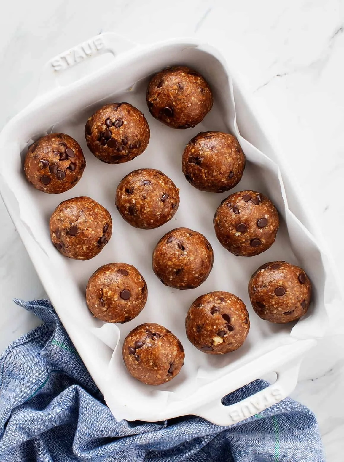 A plate of homemade no-bake energy balls made with oats and nuts.