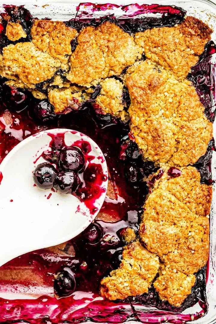 Delicious old fashioned blueberry cobbler topped with fresh blueberries and a golden crust