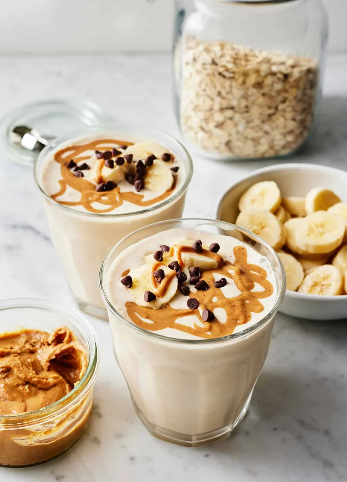 Delicious peanut butter banana smoothie in a glass with a straw