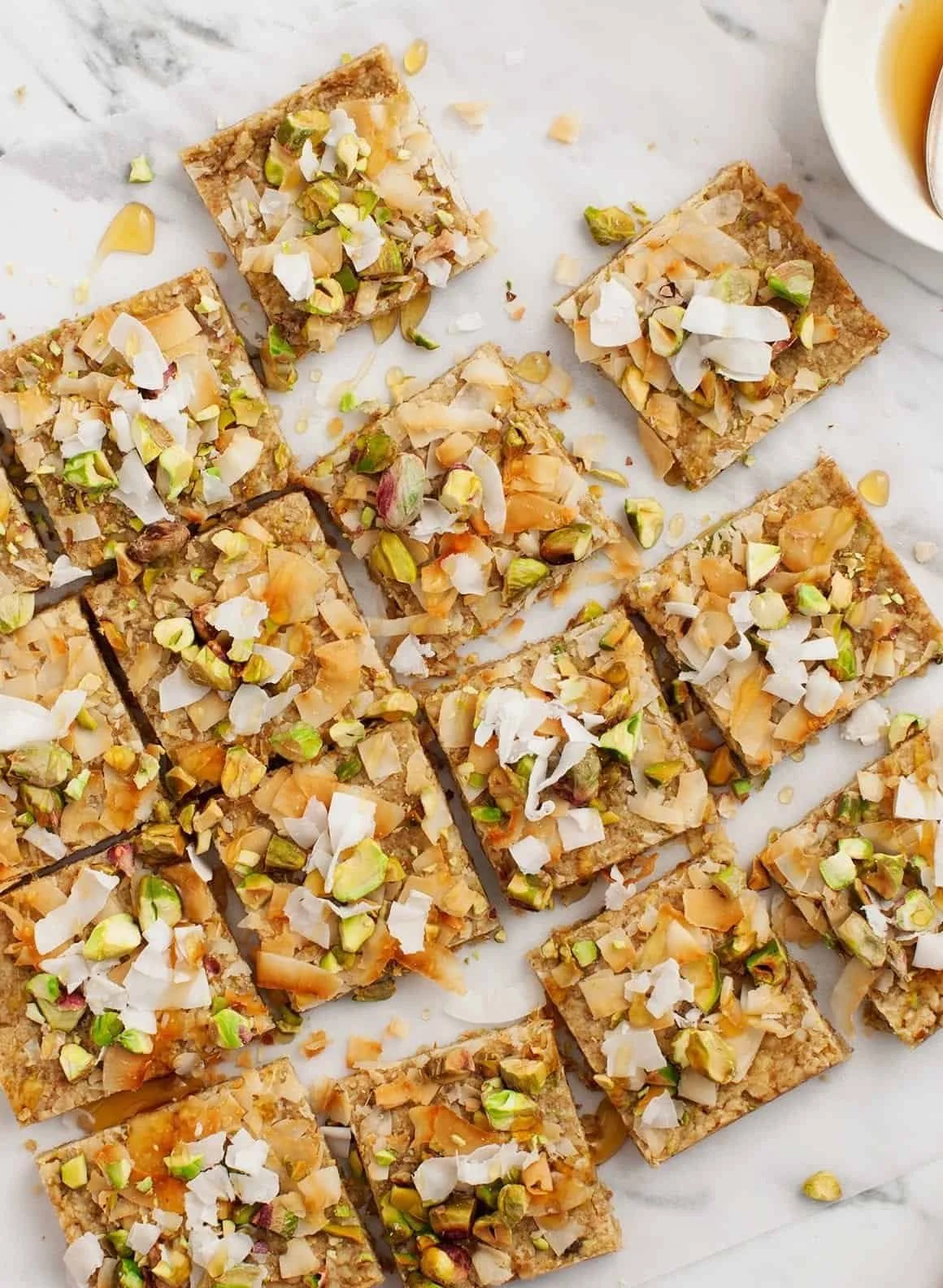 Delicious homemade Pistachio Oat Squares stacked on a plate