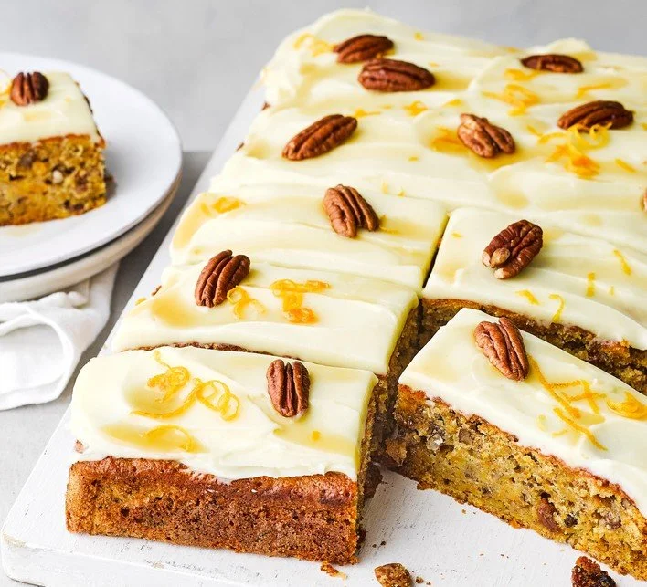 Delicious pumpkin cake topped with cream cheese frosting on a rustic table