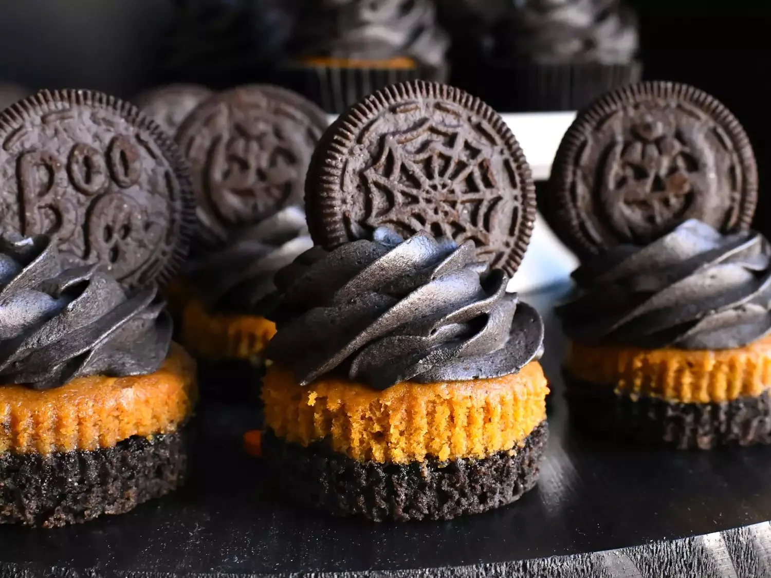 Delicious Pumpkin Oreo Cupcakes topped with cream and Oreo crumbs