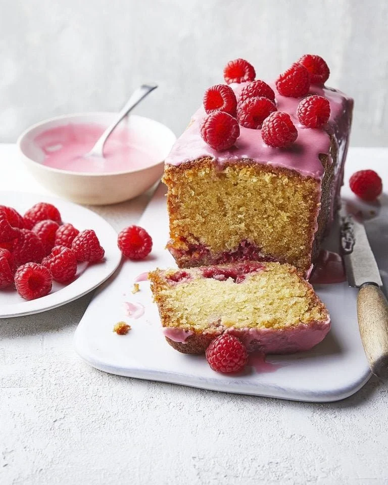 Delicious Raspberry Loaf Cake fresh out of the oven with a vibrant raspberry topping