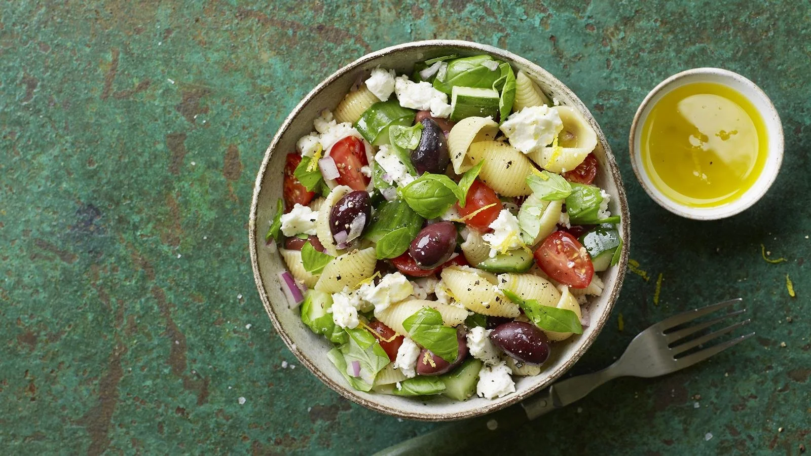 Bowl of refreshing pasta salad with colorful vegetables