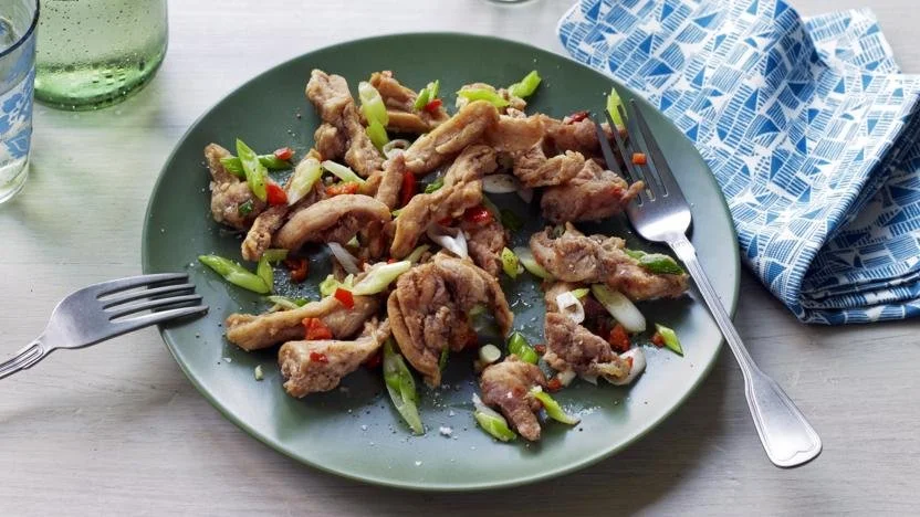Delicious plate of Salt and Pepper Chicken with vibrant garnishes