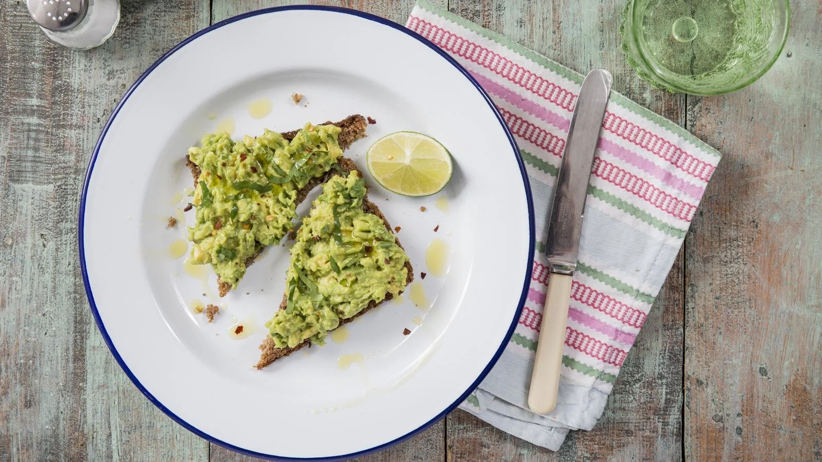 Delicious smashed avocado toast topped with cherry tomatoes and herbs