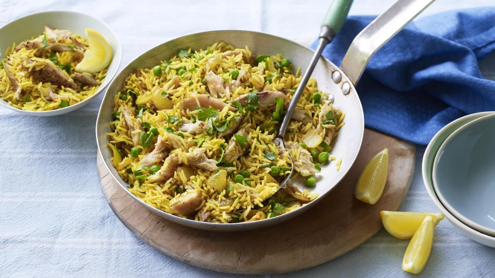 Smoked mackerel pilau rice dish garnished with herbs and spices.