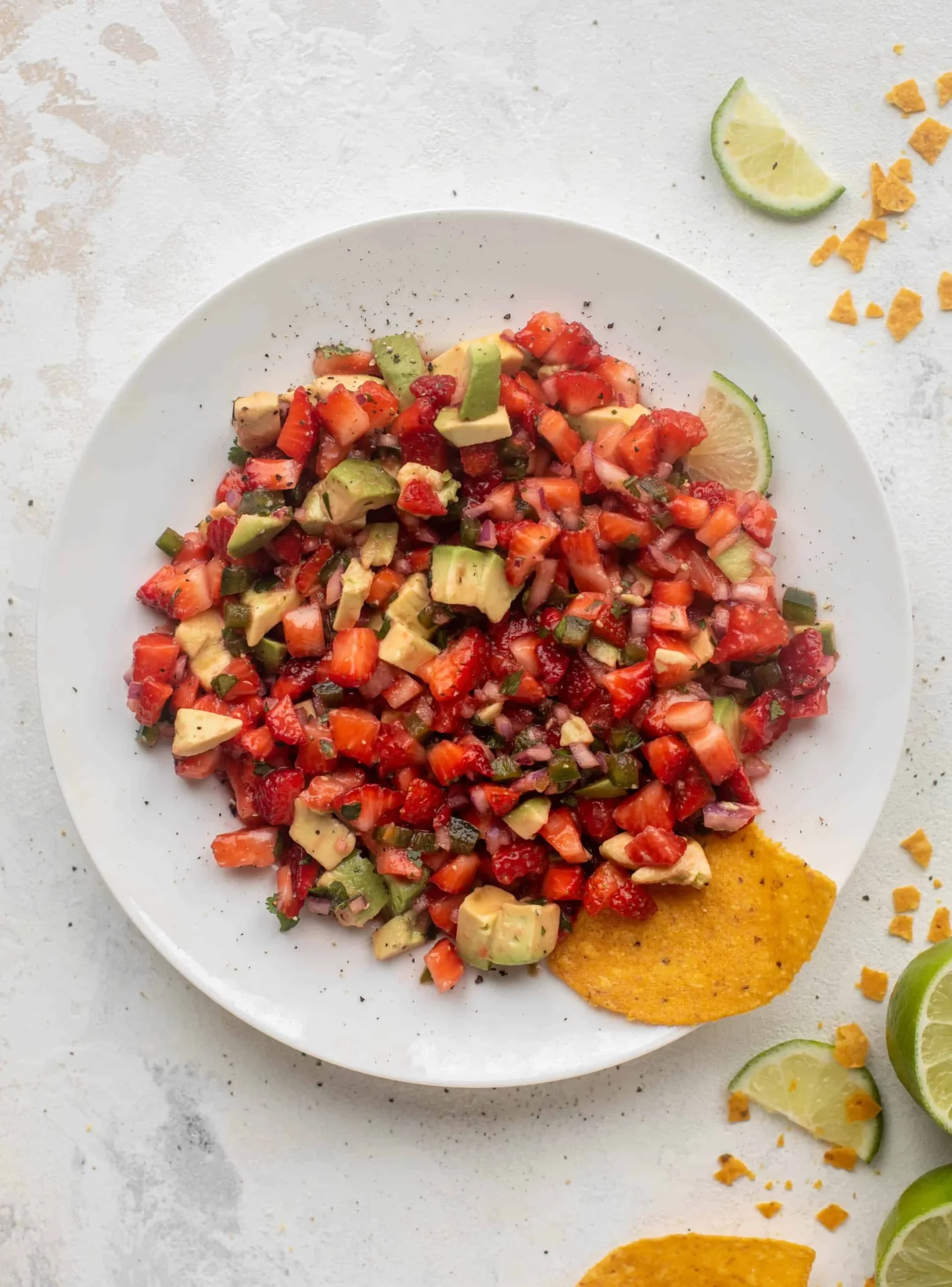 Bowl of spicy strawberry avocado salsa with fresh ingredients