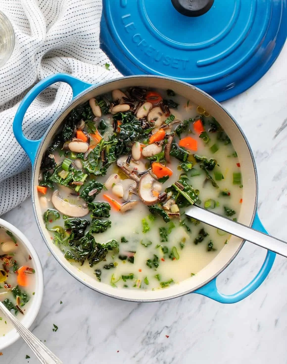 Bowl of homemade wild rice soup with vegetables and herbs